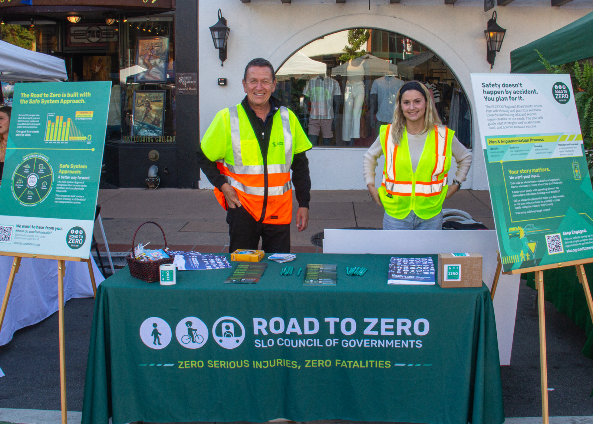 DCR team boothing at San Luis Obispo farmer's market using the marketing material we designed and produced.