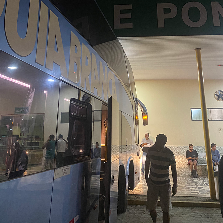 A bus stop well lit  during night time