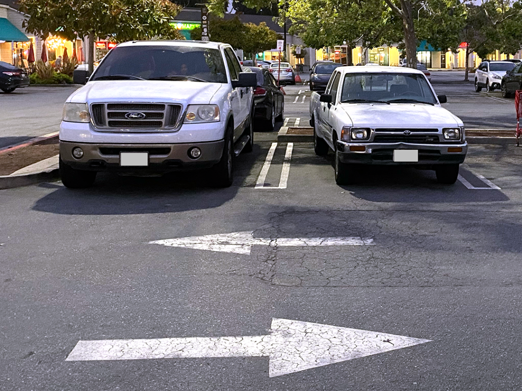 Visual comparison of an old Toyota truck model that is smaller versus a new Toyota truck model that is huge and bulky. 