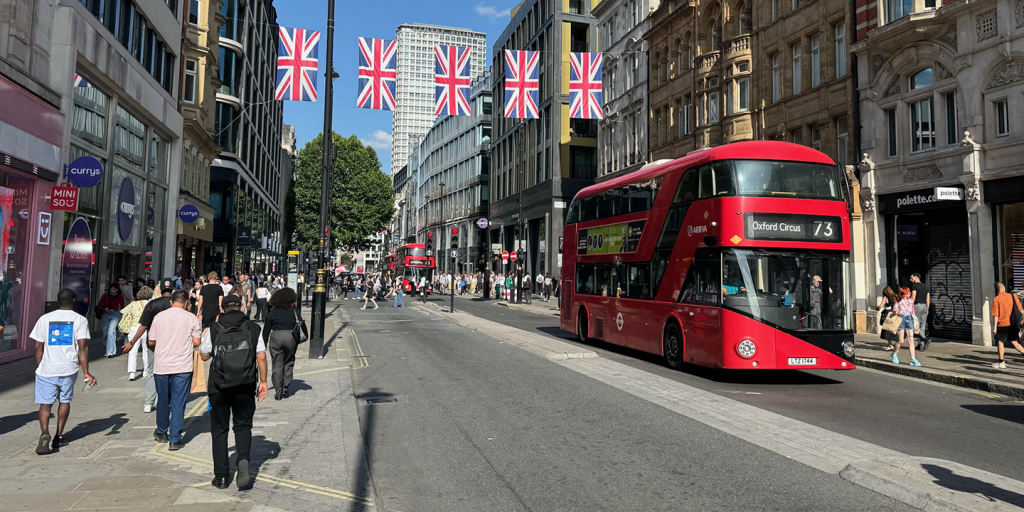 Active streets of London featuring tram and pedestrians. 